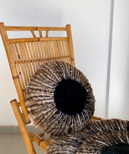 Real fur pillows and throw with black fox fur, natural fur bedding in animal printed brown fur home decoration, interior luxury fur gift.